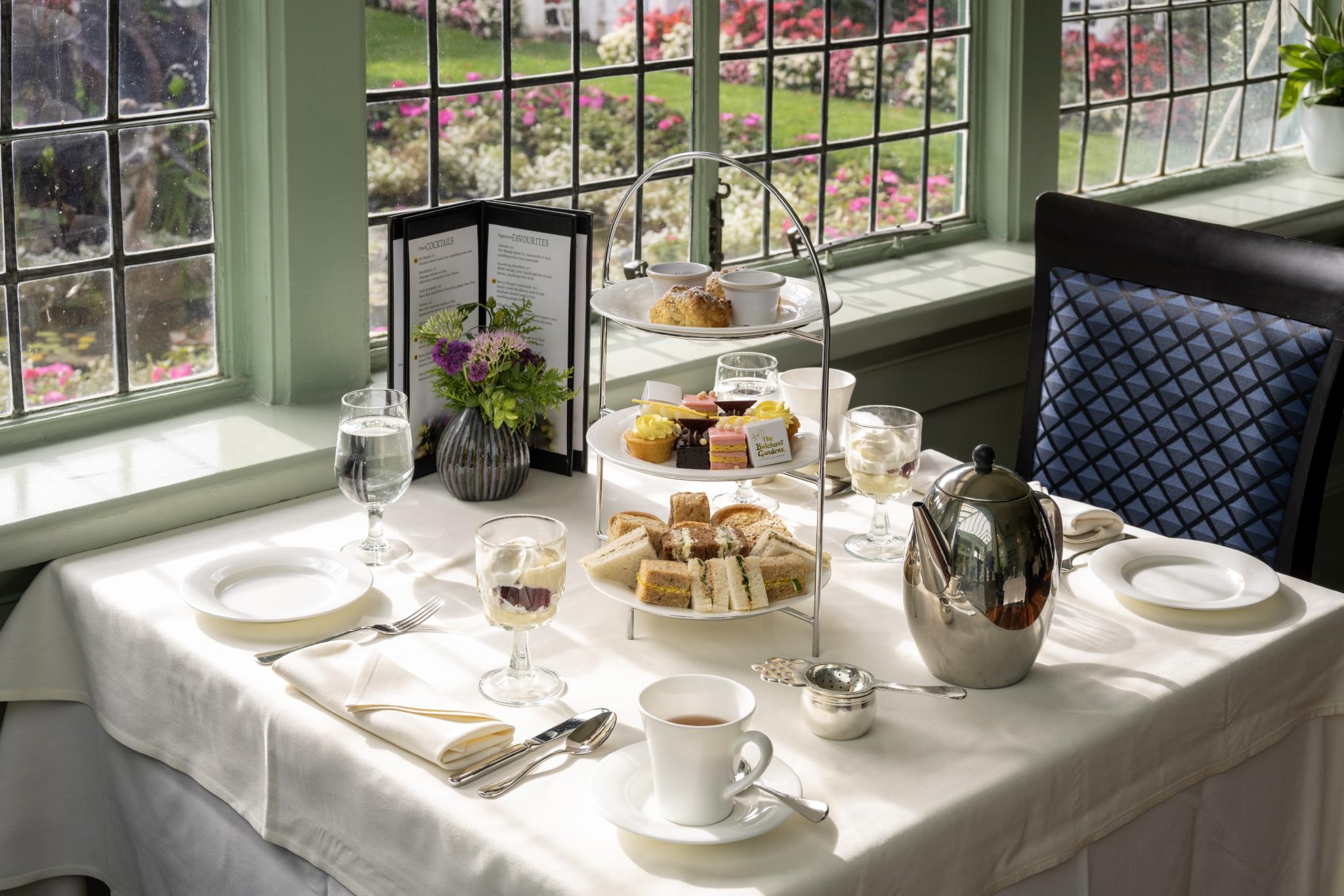 Afternoon tea with a three-tiered tower of sweet and savory items, trifle and tea.