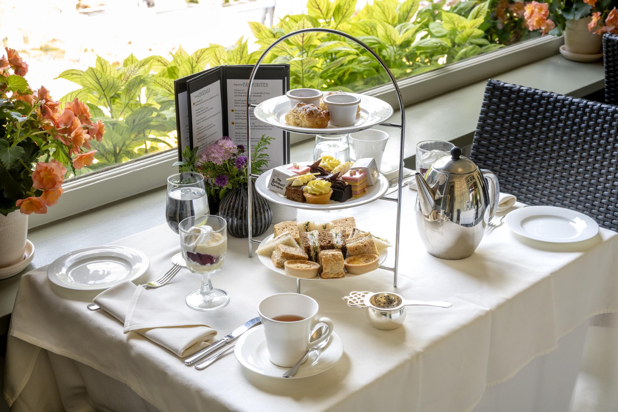 Afternoon tea with a three-tiered tower of sweet and savory items, trifle and tea.