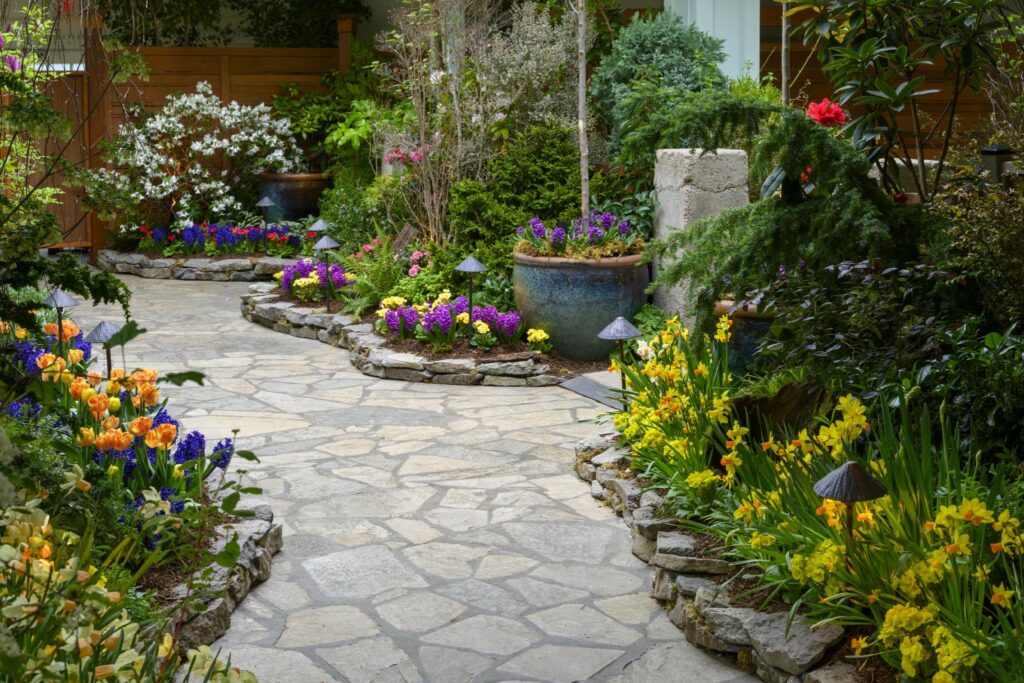 Indoor garden with flagstone pathways and early spring blooms.